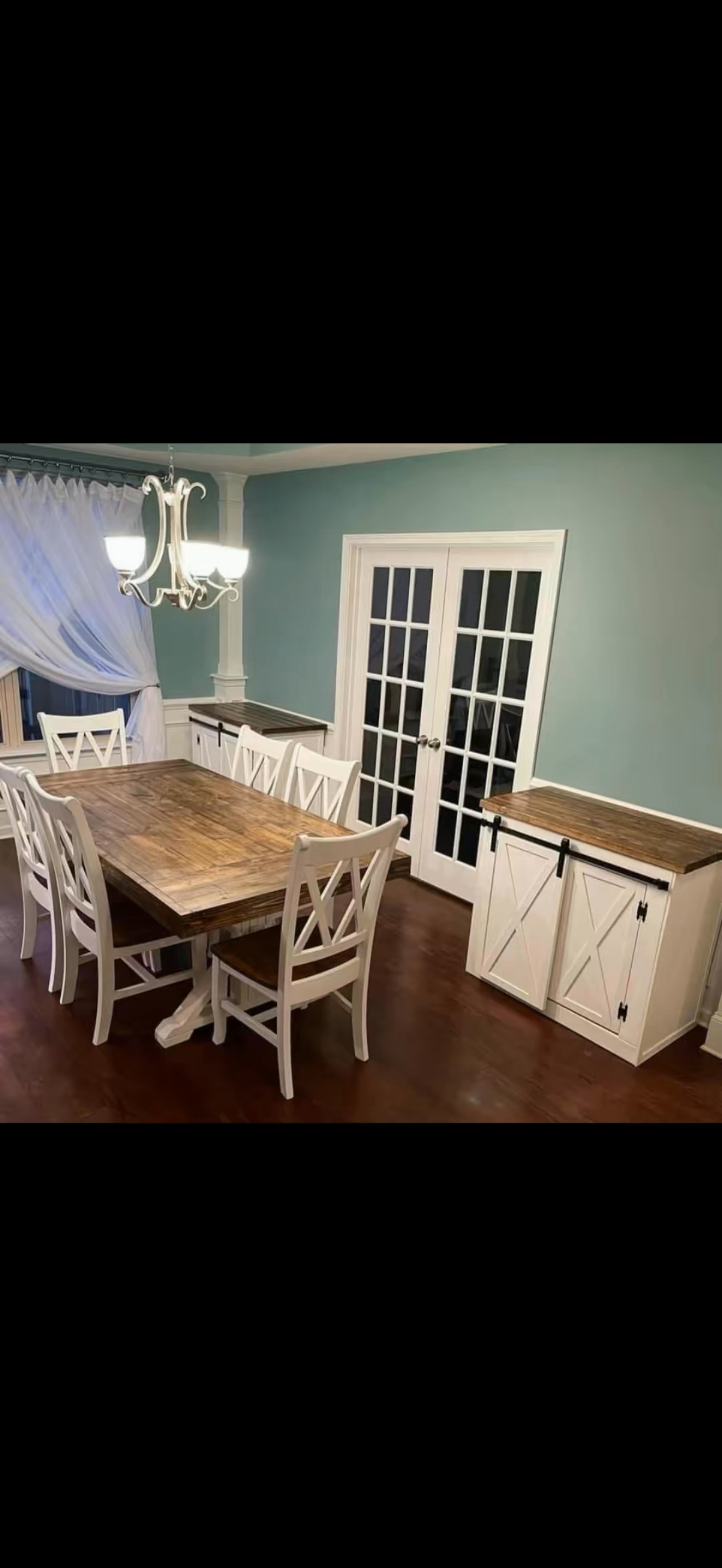 Barn-door dining storage. White barn-door cabinets with wood tops, shown alongside a coordinating dining table.