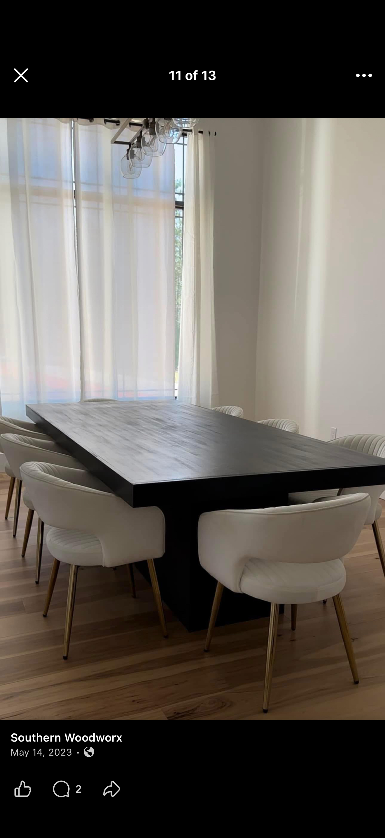 The dark modern table. A substantial rectangular top with a clean, dark finish.