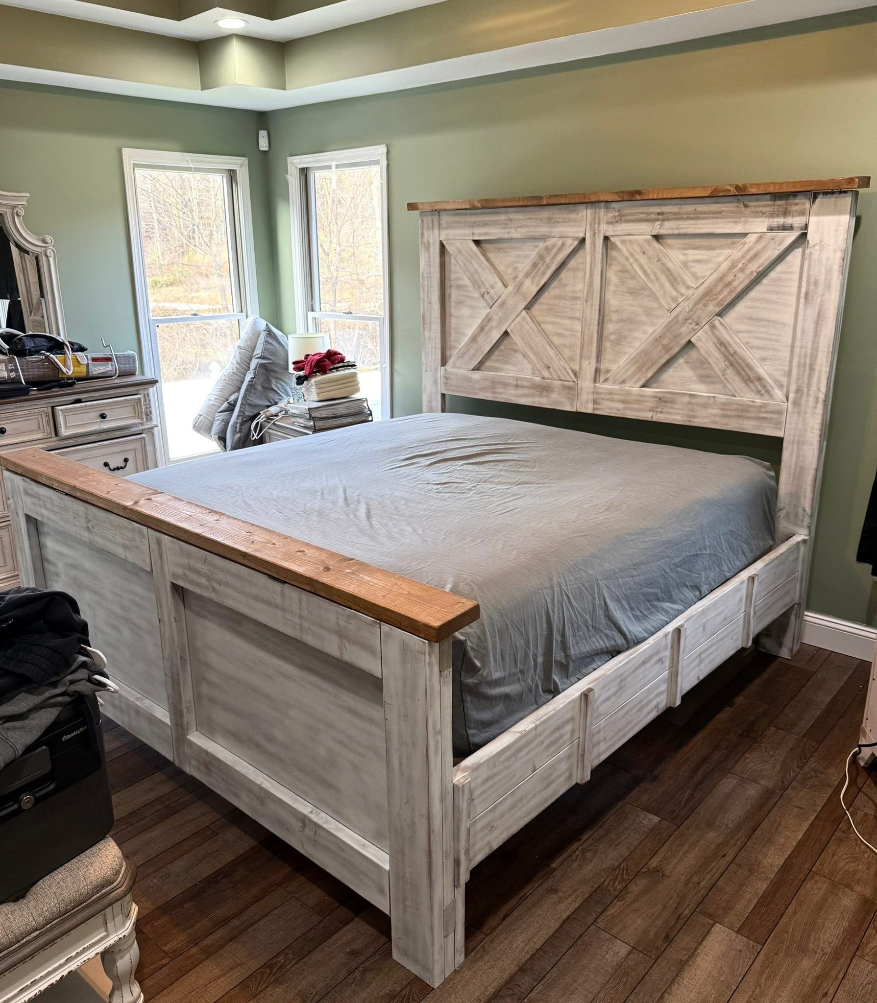 Whitewashed X-panel bed with contrasting wood trim